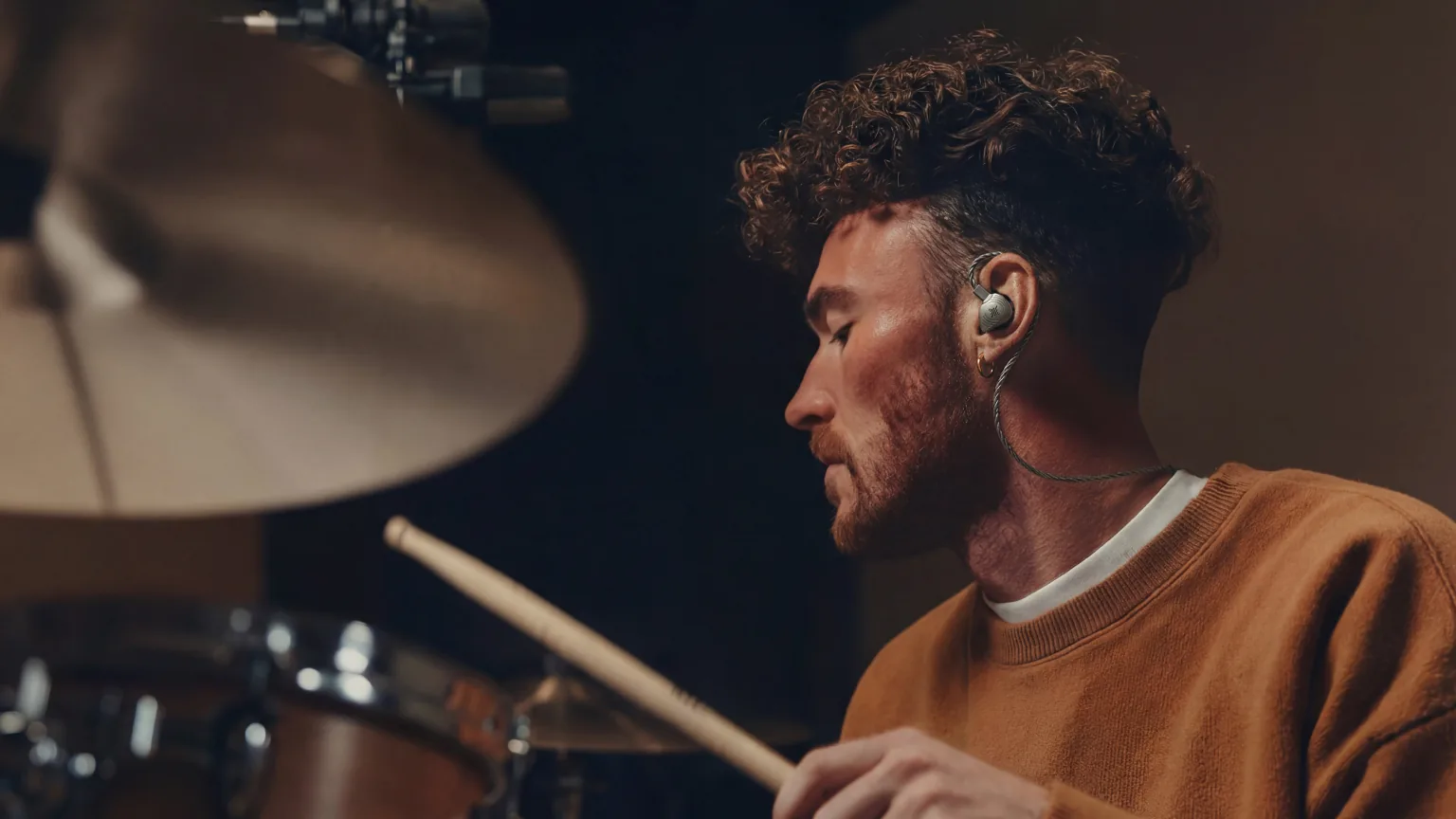 Drummer wearing Soundbrenner Wave Pro 2 in-ear monitors